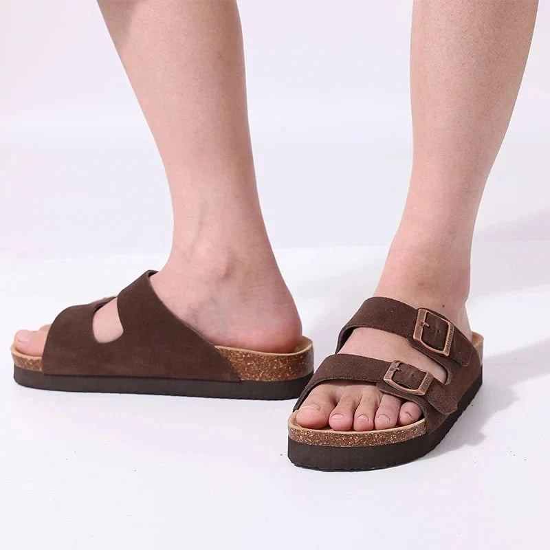 Cream sandals with two buckle straps and a contoured cork footbed