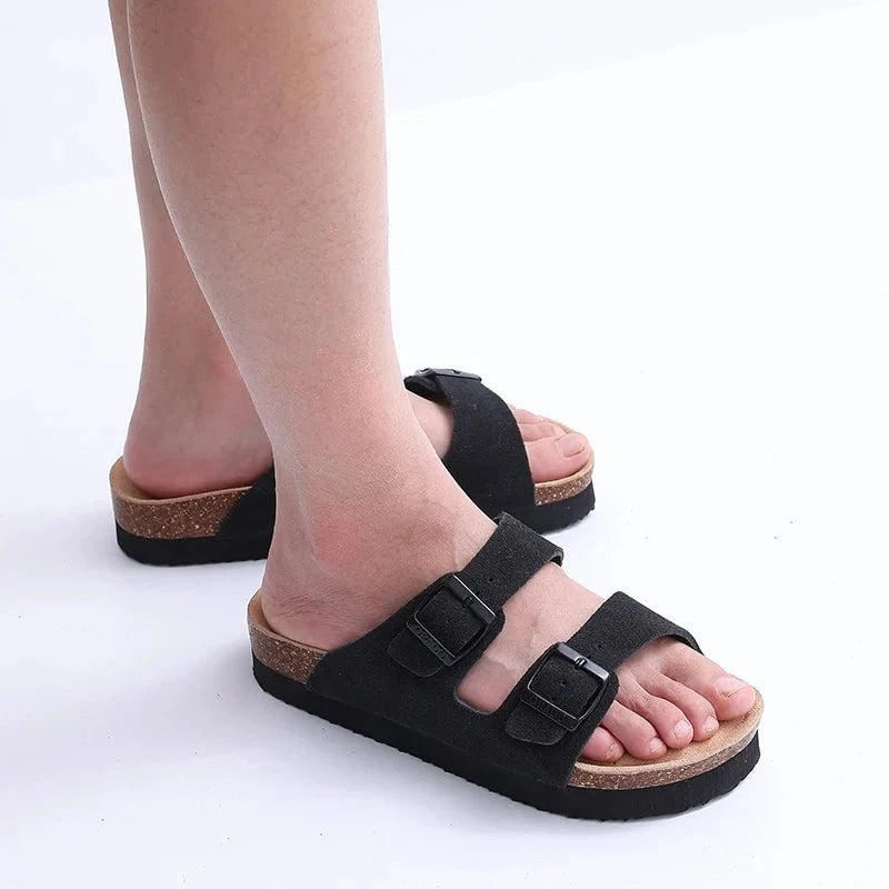 Cream sandals with two buckle straps and a contoured cork footbed