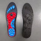 Blue and red acupressure insoles covered with raised massage nubs, placed inside the shoe