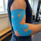 Set of elastic elbow straps worn just below the joint, in blue, black and khaki