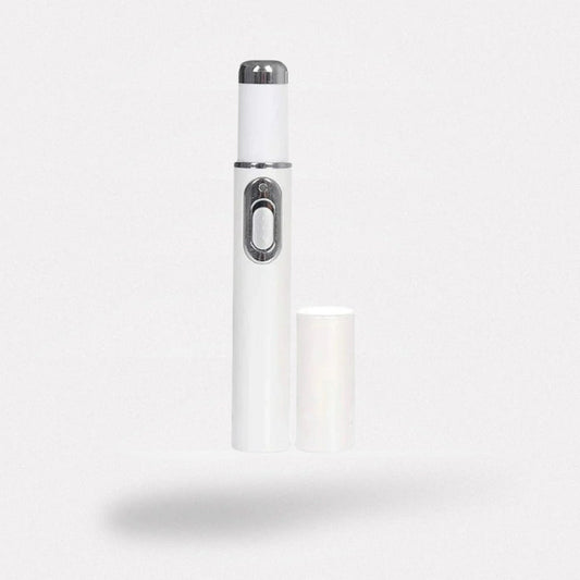 Handheld laser pen held over the toenail to treat nail fungus at home